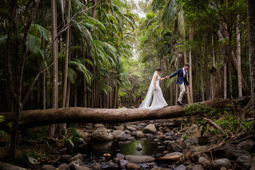 Bride and Groom walk through the forest for their wedding photos Wedding Photography at Cedar Creek Lodges 