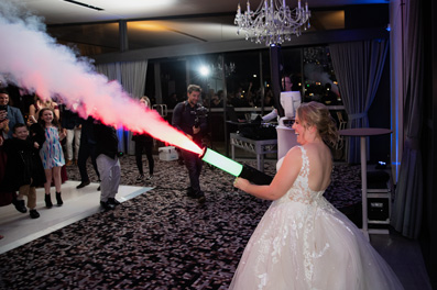 Bride and her smoke bomb at wedding reception at Sandstone Point Hotel