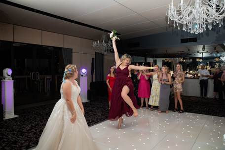 Bridesmaid catches the bouquet at Sandstone Point Hotel Wedding